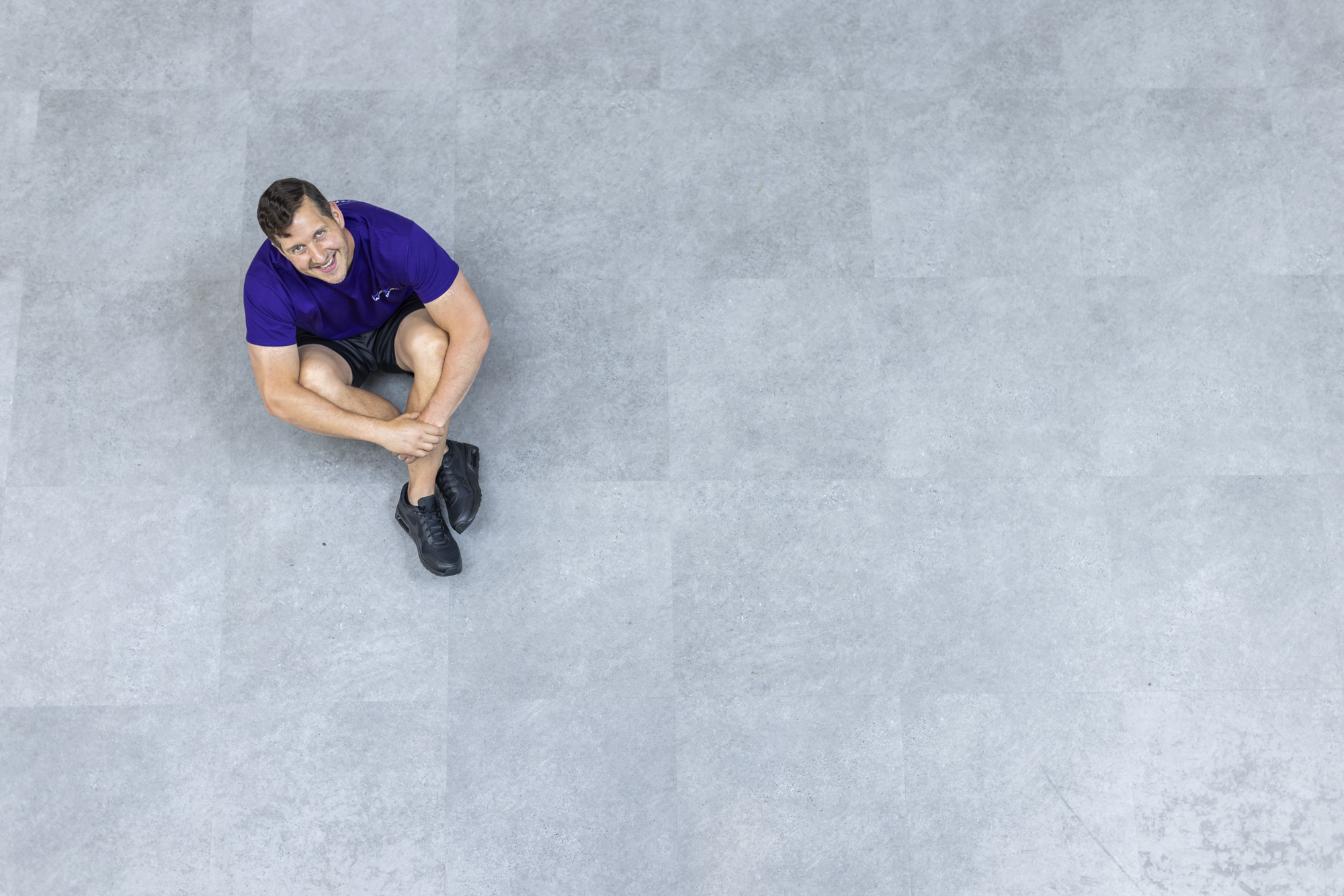 Personal trainer supporting a client with strength training in Luton